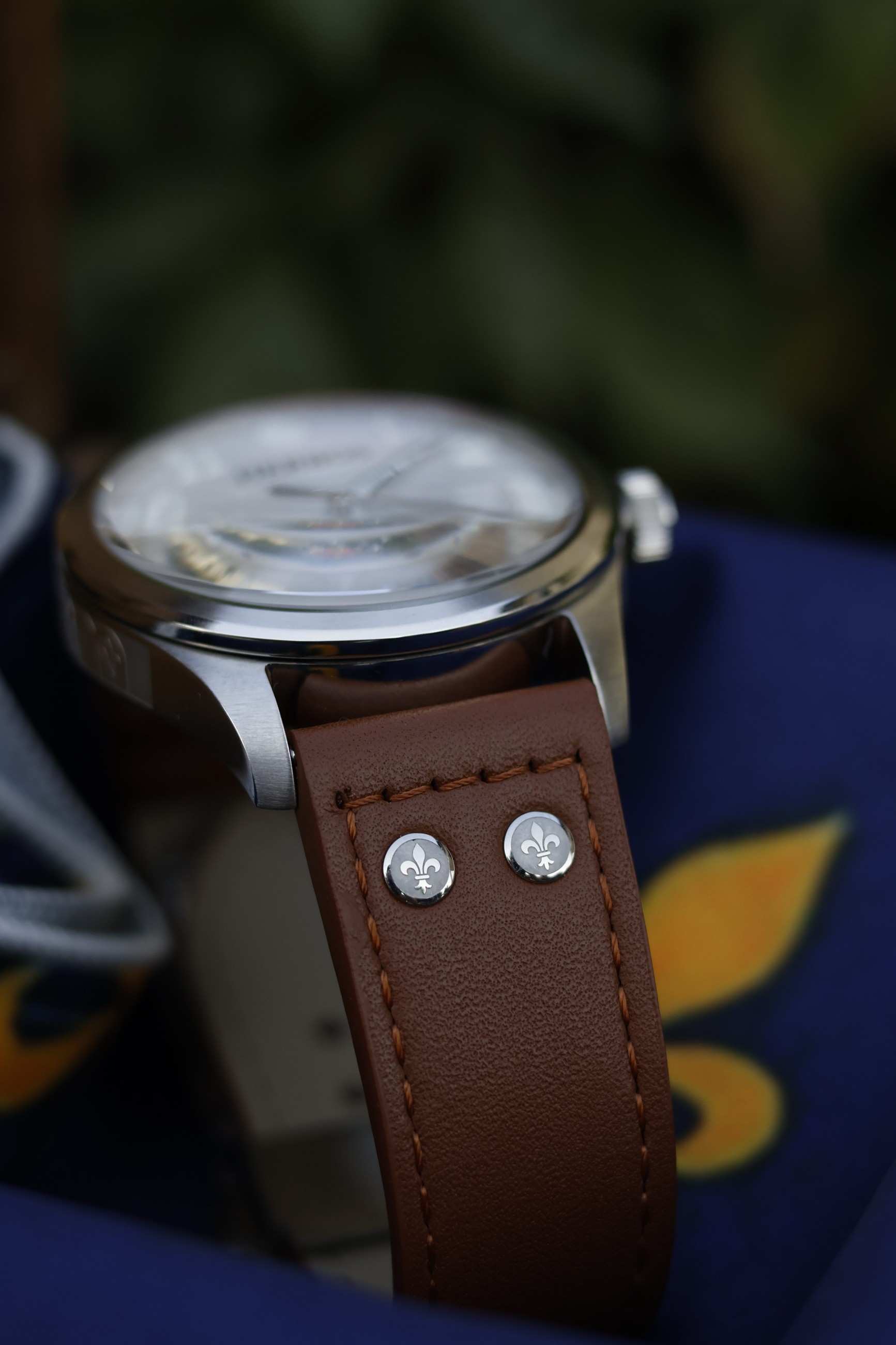 Case lug and a lily rivet on the brown leather strap