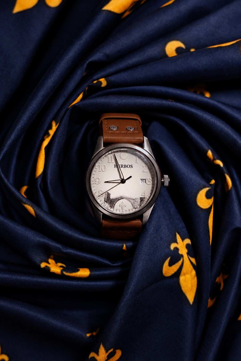 The Herbos Stari Most Edition on blue fabric with golden lilies